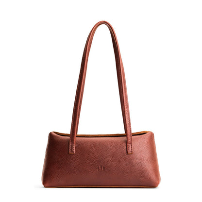 Nutmeg | Leather bowler bag with magnetic closure against a white background