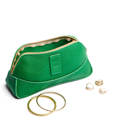 Jolly Green | Handmade leather makeup bag pouch with top zipper open next to gold jewelry