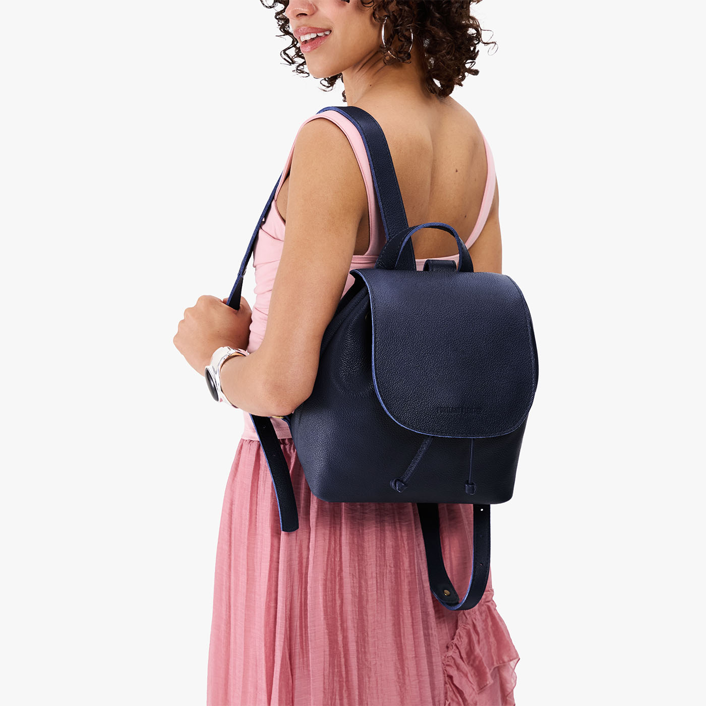 Cobalt | Pebbled leather drawstring backpack being worn by a person