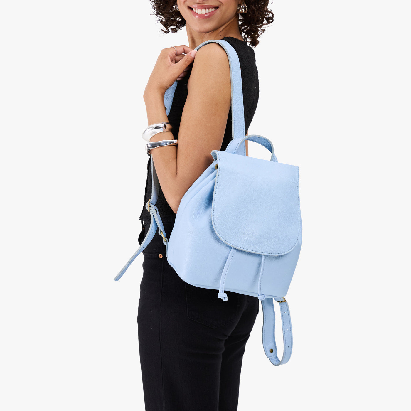 Skyway | Pebbled leather drawstring backpack being worn by a person