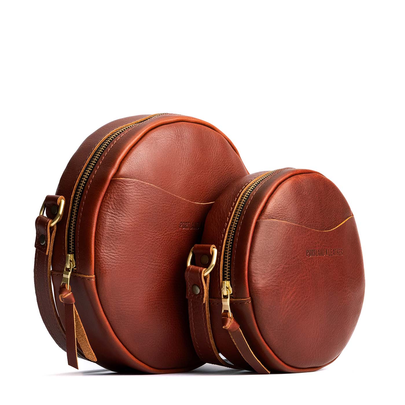 Chestnut | Size comparison image of small and large circle shaped crossbody bags with top zipper