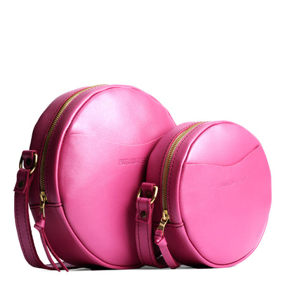 Lip Gloss | Size comparison image of small and large circle shaped crossbody bags with top zipper