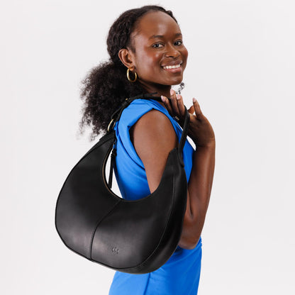 Black*Large | Large crescent shaped shoulder bag with zipper closure and adjustable strap
