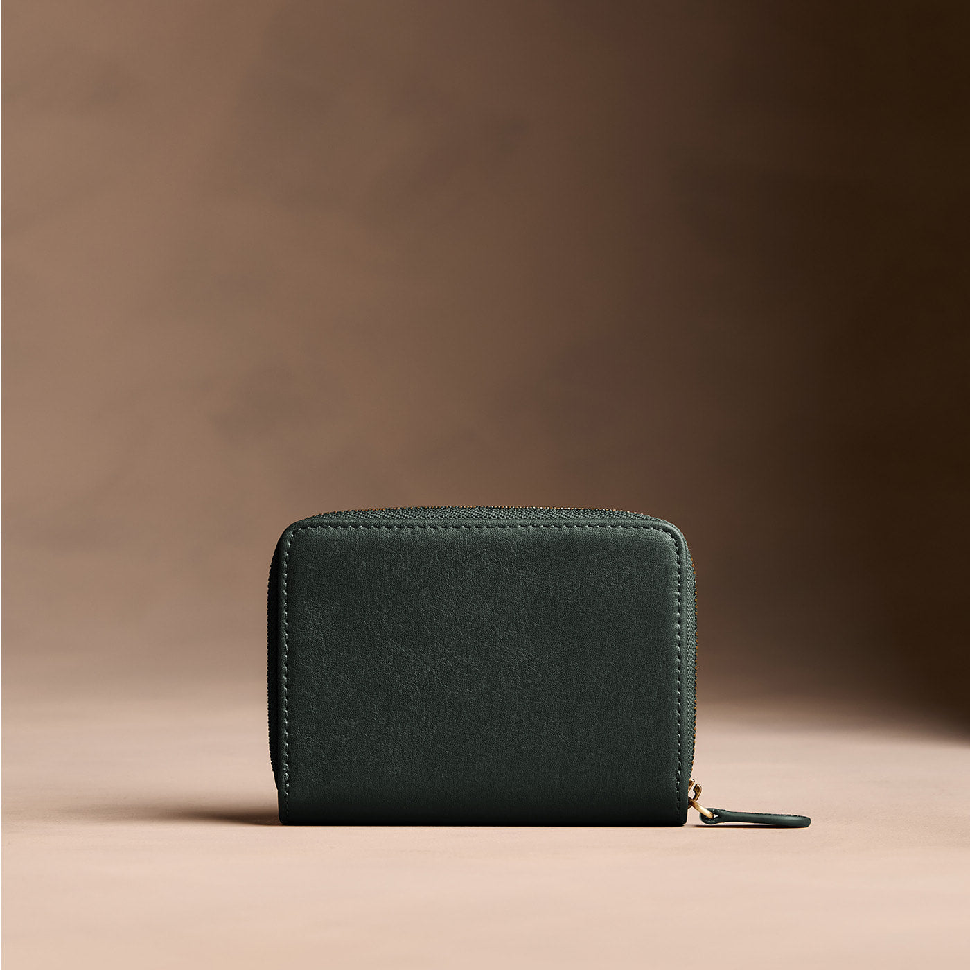 Regent Green | Wallet with card and storage pockets on a light brown background - back view