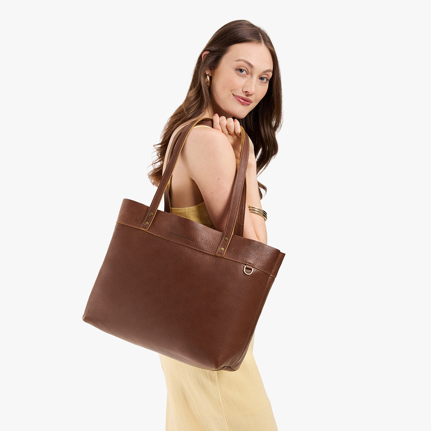 Asheville*Large*Classic | Model wearing leather tote bag with riveted straps and exterior key loop