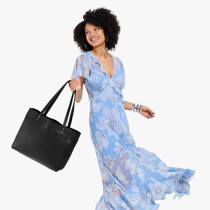 Pebbled--black*Large*Classic | Model wearing leather tote bag with riveted straps and exterior key loop