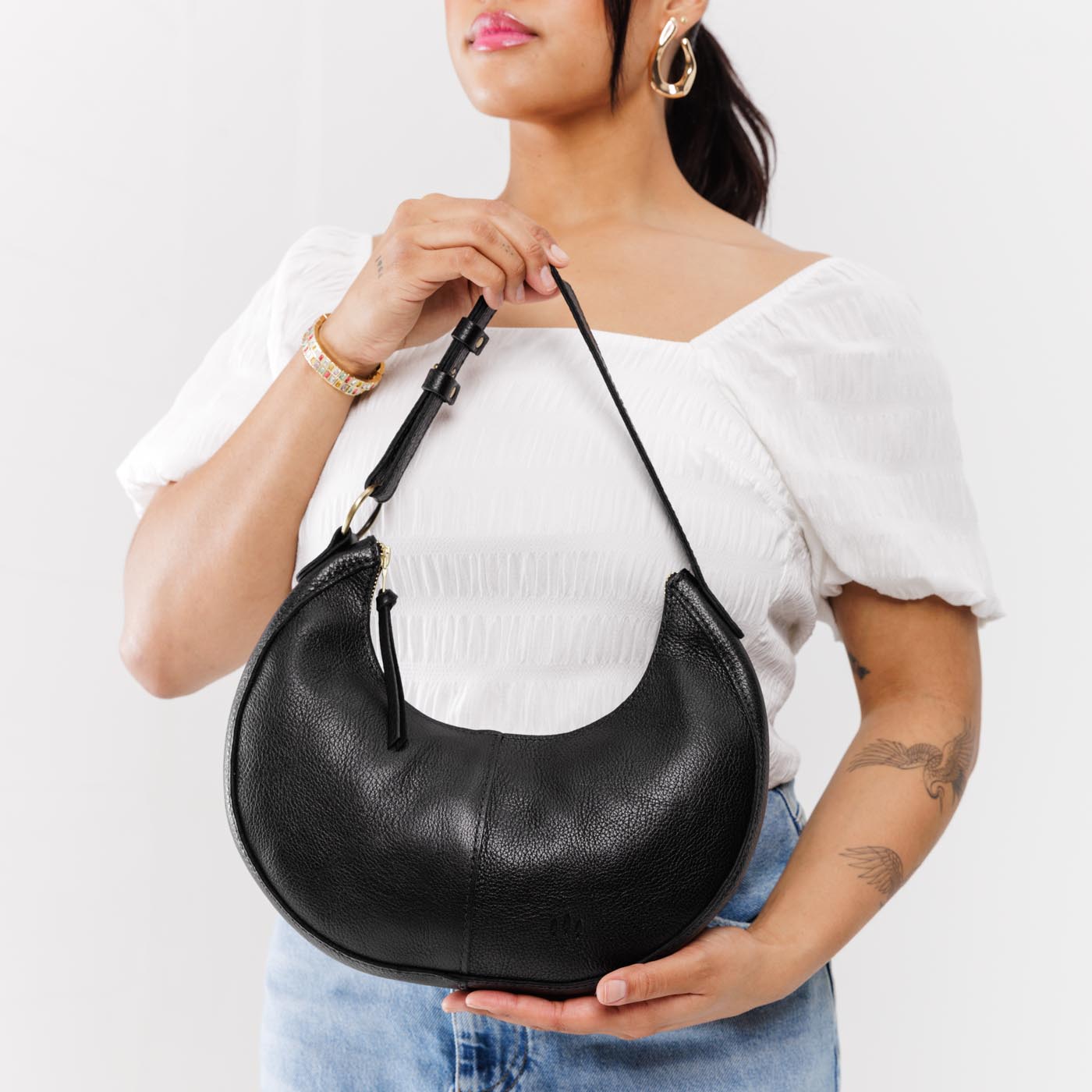 Pebbled--black*Small | Crescent shaped shoulder bag with zipper closure and adjustable strap