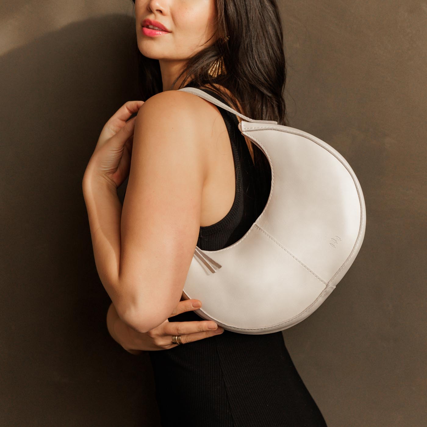 Bone*Small | Crescent shaped shoulder bag with zipper closure and adjustable strap
