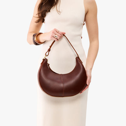 Cognac*Small | Crescent shaped shoulder bag with zipper closure and adjustable strap