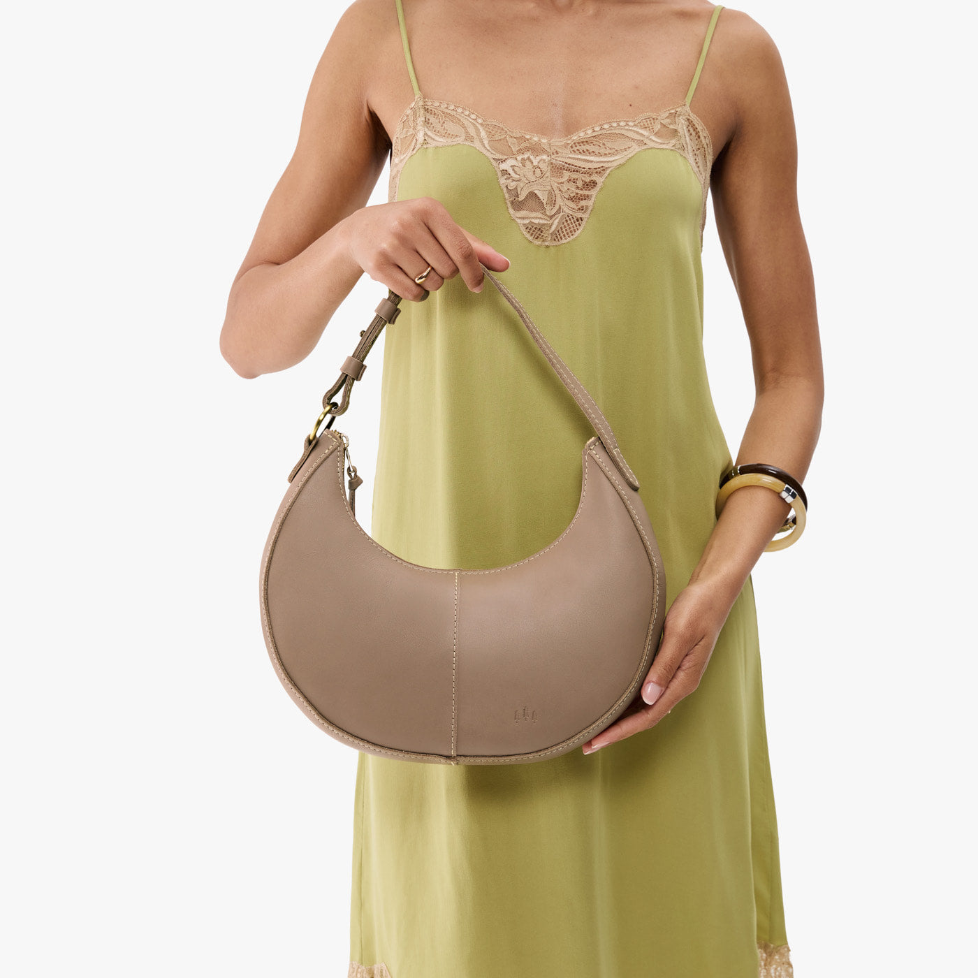 Stone*Small | Crescent shaped shoulder bag with zipper closure and adjustable strap
