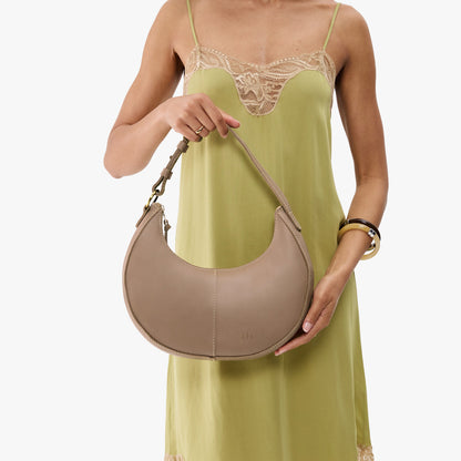 Stone*Small | Crescent shaped shoulder bag with zipper closure and adjustable strap