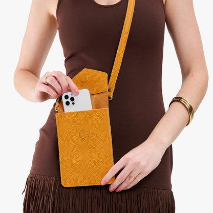 Sunshine | Model wearing slim, phone-shaped crossbody purse with magnetic closure