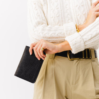 Pebbled--black | Model holding leather passport case with PLG logo