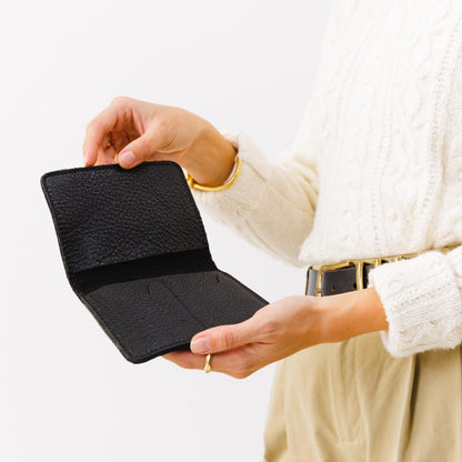 Pebbled--black | Model holding leather passport case with PLG logo