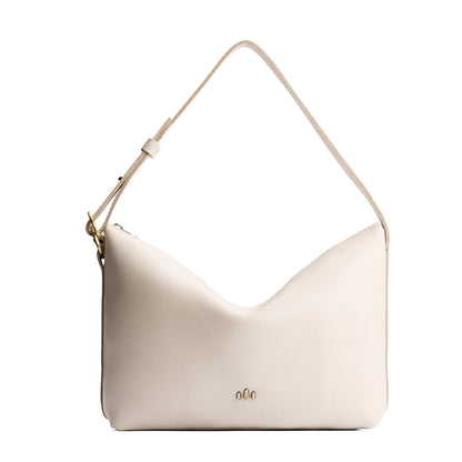 Pebbled Bone*Large | Model Wearing medium sized slouchy leather shoulder bag with zipper opening and three metal tree emblems